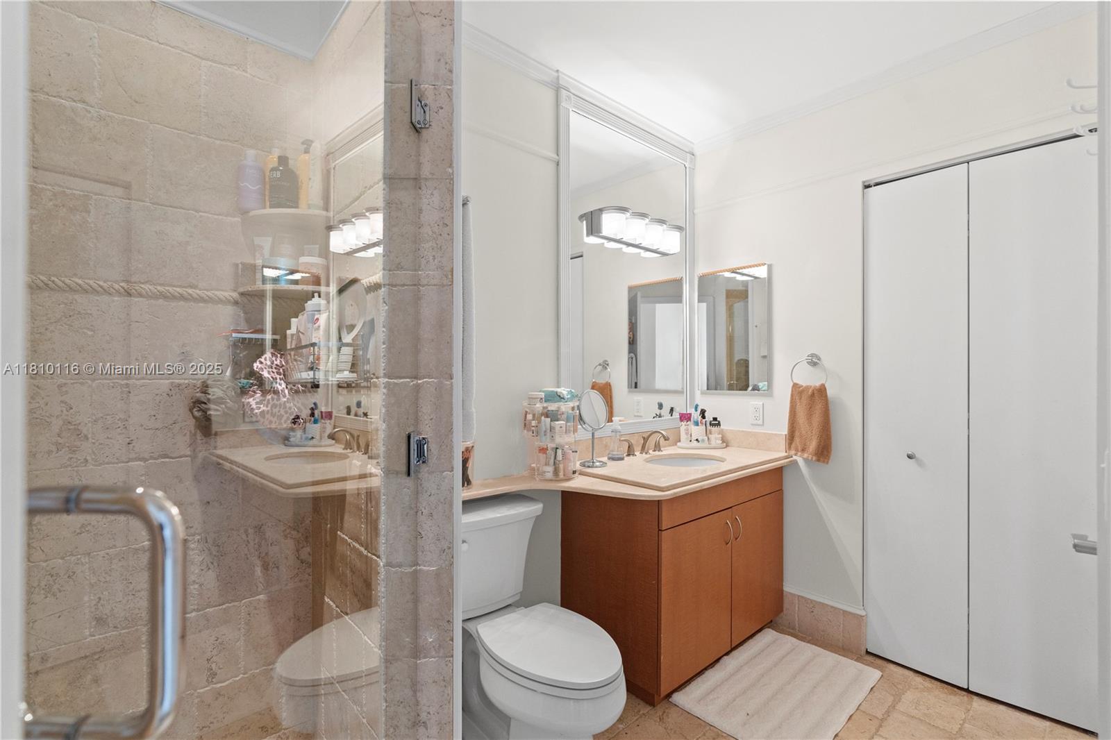 4775 Collins Avenue, Unit PH4107 Miami Beach, FL 33140 - Photo 40 of 62 a bathroom with a sink a toilet and shower