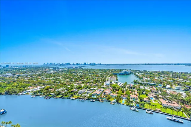 a living room with furniture large windows and view of living room