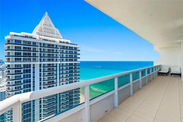 a view of a living room with a floor to ceiling window and an empty room