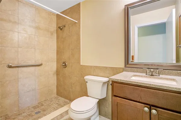 a bathroom with a sink a toilet and shower