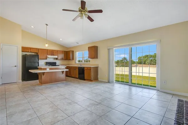 a large kitchen with a stove a sink dishwasher and a refrigerator