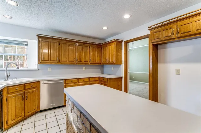a kitchen with stainless steel appliances granite countertop sink stove and refrigerator