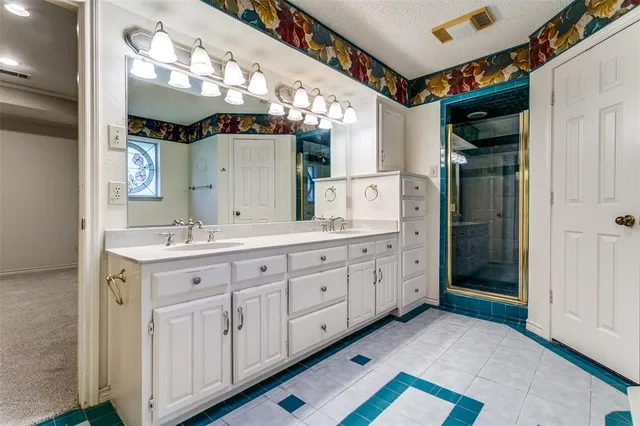 a spacious bathroom with a double vanity sink and a mirror