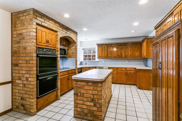 a kitchen with stainless steel appliances granite countertop a stove and a refrigerator