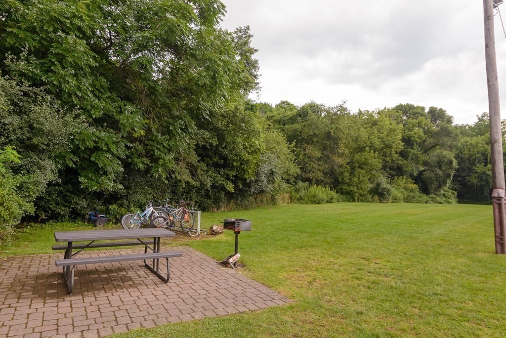 20 Westgate Road, Unit 4 Chestnut Hill, MA 02467 - Photo 14 of 16 a bench sitting in the middle of a field