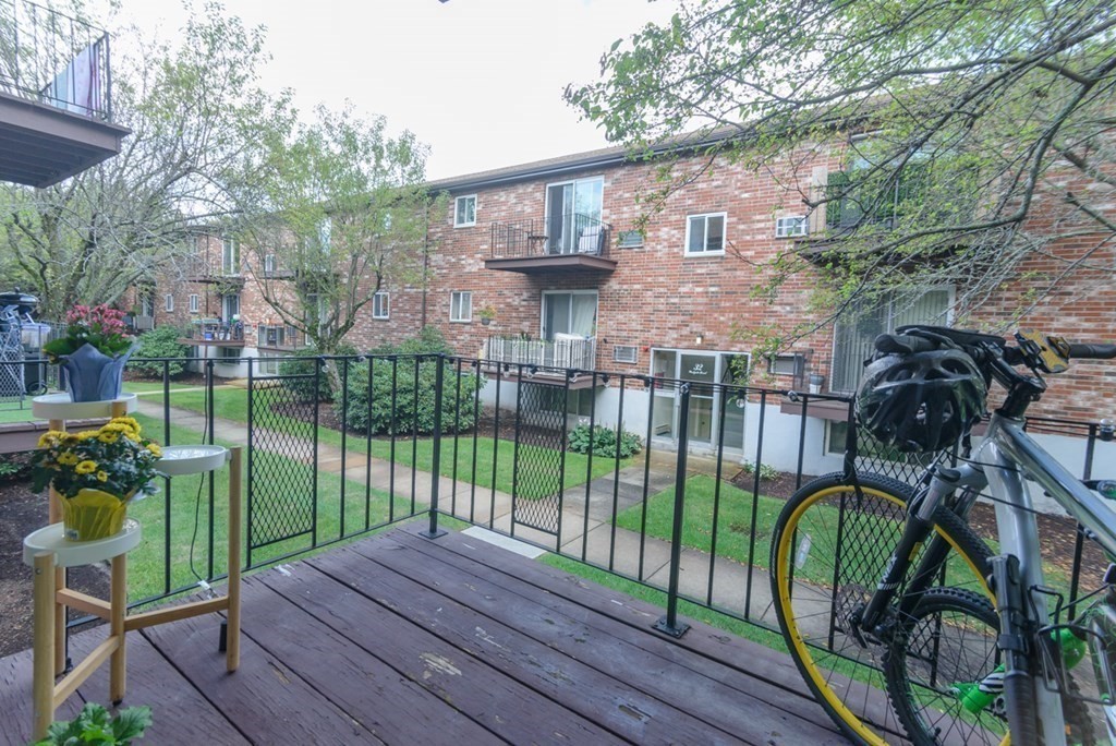 20 Westgate Road, Unit 4 Chestnut Hill, MA 02467 - Photo 8 of 16 a view of a deck with chairs and a yard