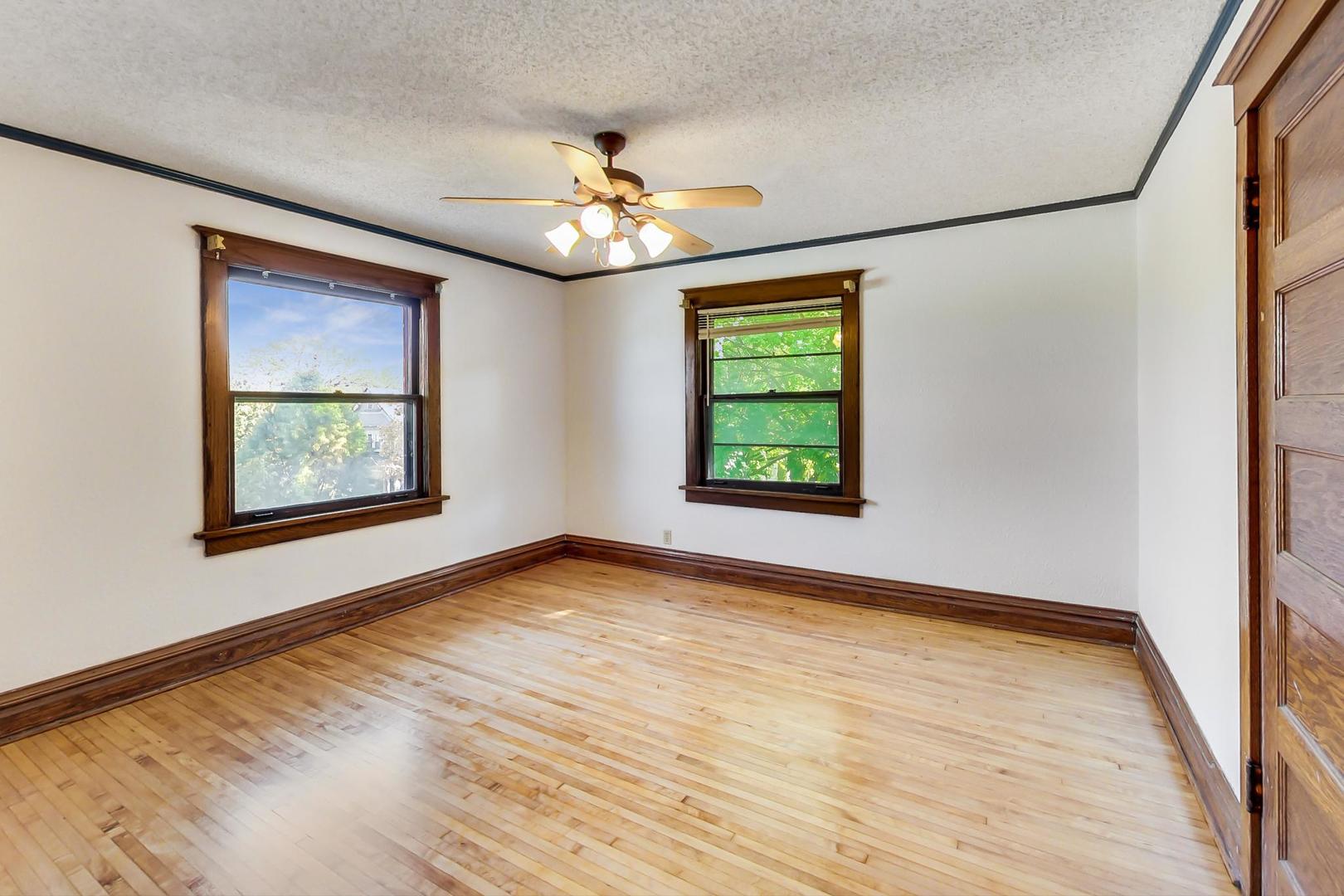 37 7th Avenue La Grange, IL 60525 - Photo 13 of 45 a view of an empty room with a window and wooden floor