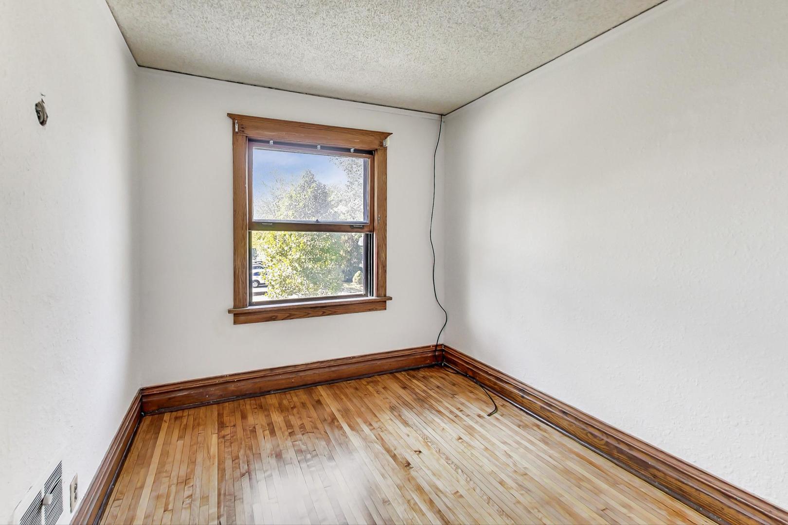 37 7th Avenue La Grange, IL 60525 - Photo 15 of 45 a view of an empty room with wooden floor and a window