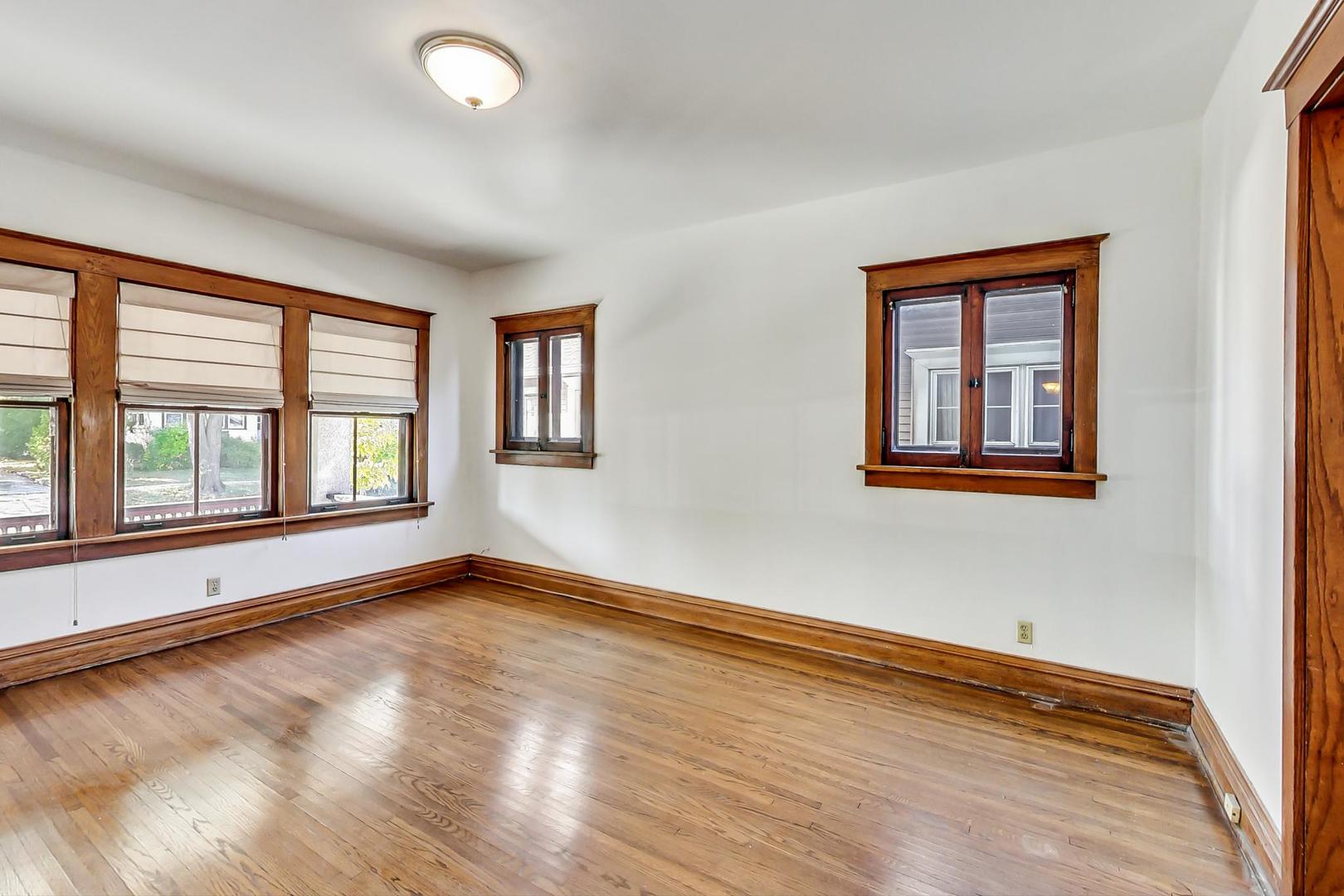 37 7th Avenue La Grange, IL 60525 - Photo 23 of 45 a view of an empty room with a window and wooden floor