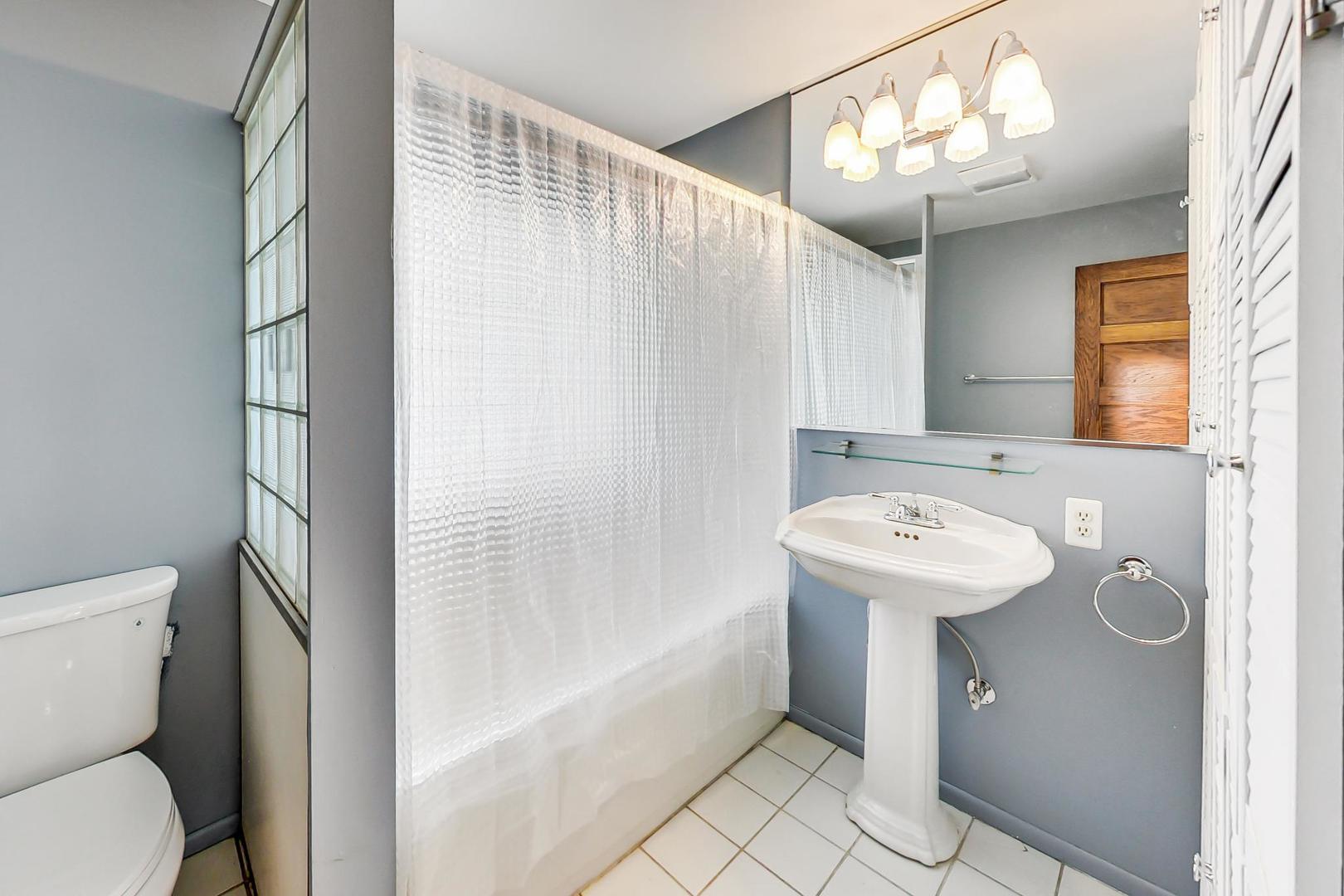 37 7th Avenue La Grange, IL 60525 - Photo 27 of 45 a bathroom with a sink a toilet and shower