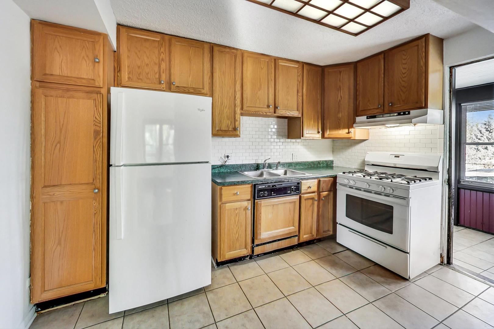 37 7th Avenue La Grange, IL 60525 - Photo 9 of 45 a kitchen with a refrigerator sink and cabinets