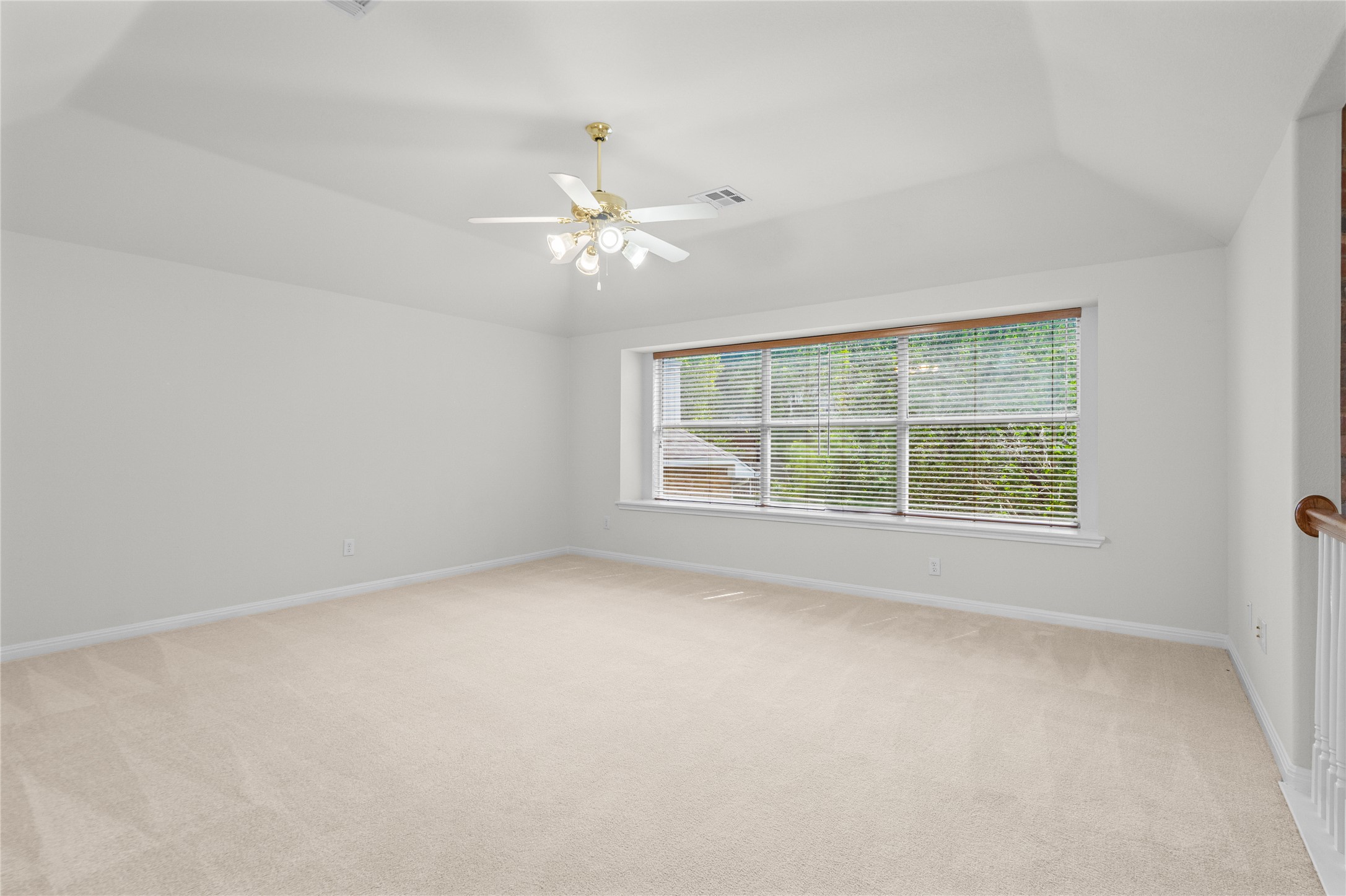10700 Pointe View Drive Austin, TX 78738 - Photo 18 of 35 A spacious and inviting room features soft carpeting and abundant natural light from a large window.