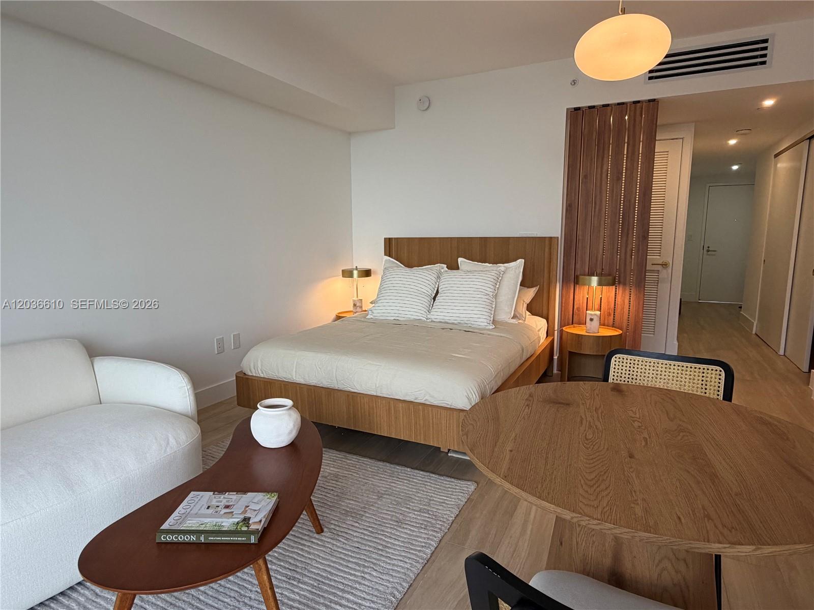 90 Northeast 32nd Street, Unit 1014 Miami, FL 33127 - Photo 3 of 39 a bedroom with bed and a couch