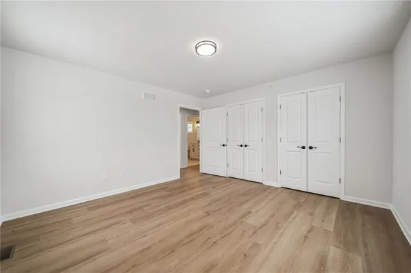 a view of an empty room and wooden floor