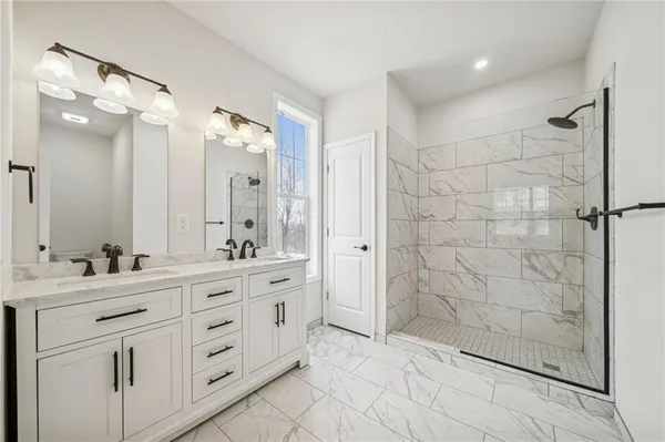 a bathroom with a double sink shower and a mirror