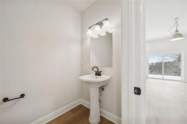 a bathroom with a sink mirror and toilet