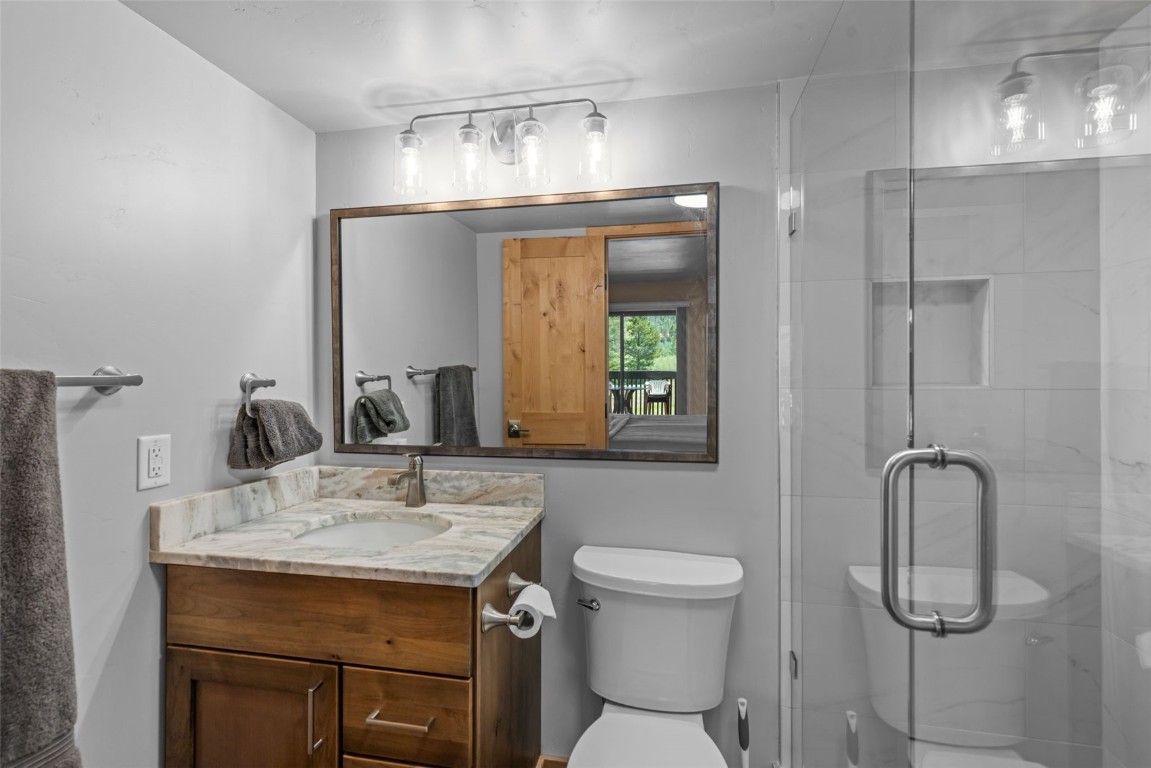 500 Bills Ranch Road, Unit 161 Frisco, CO 80443 - Photo 19 of 38 a bathroom with a sink a toilet and a mirror