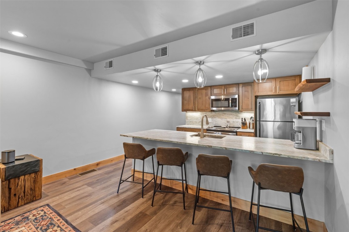500 Bills Ranch Road, Unit 161 Frisco, CO 80443 - Photo 4 of 38 a kitchen with stainless steel appliances a dining table chairs and wooden floor