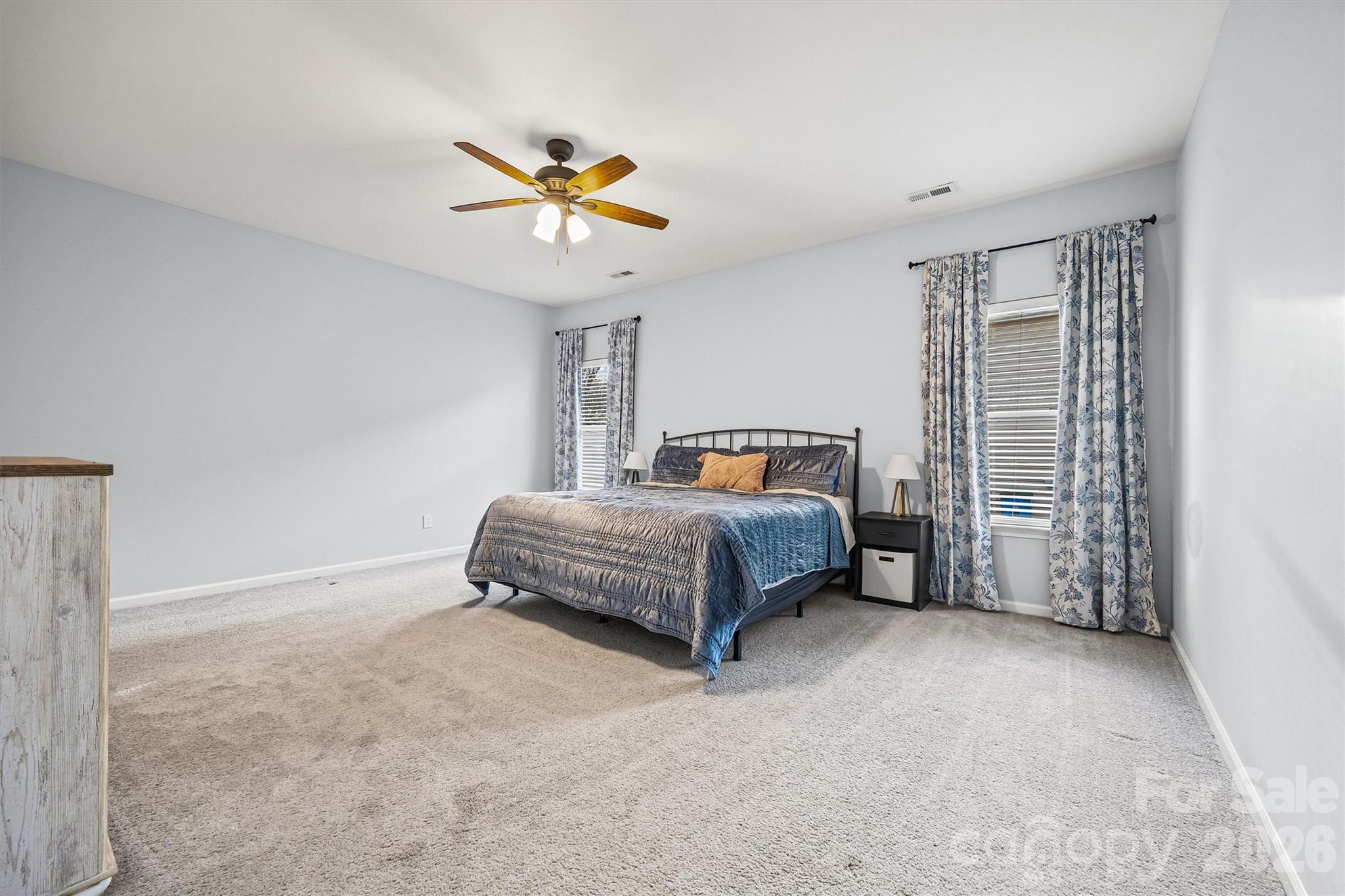 2133 Seabrook Lane Fort Mill, SC 29715 - Photo 14 of 28 a bedroom with a bed and a chandelier