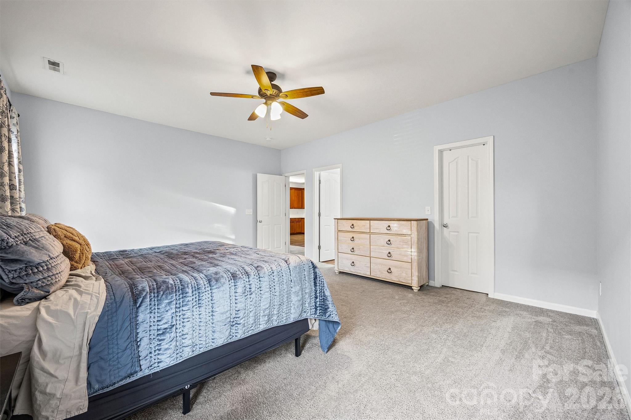 2133 Seabrook Lane Fort Mill, SC 29715 - Photo 15 of 28 a bedroom with a bed and a chandelier