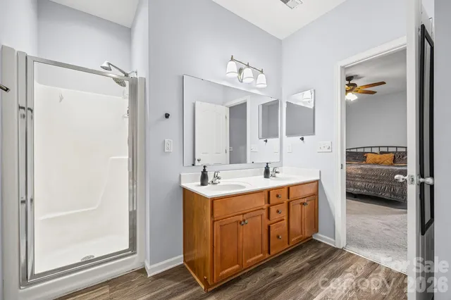 a spacious bathroom with a double vanity sink and a mirror