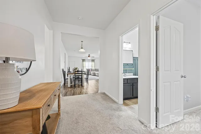 a kitchen with granite countertop stainless steel appliances a refrigerator cabinets and wooden floor