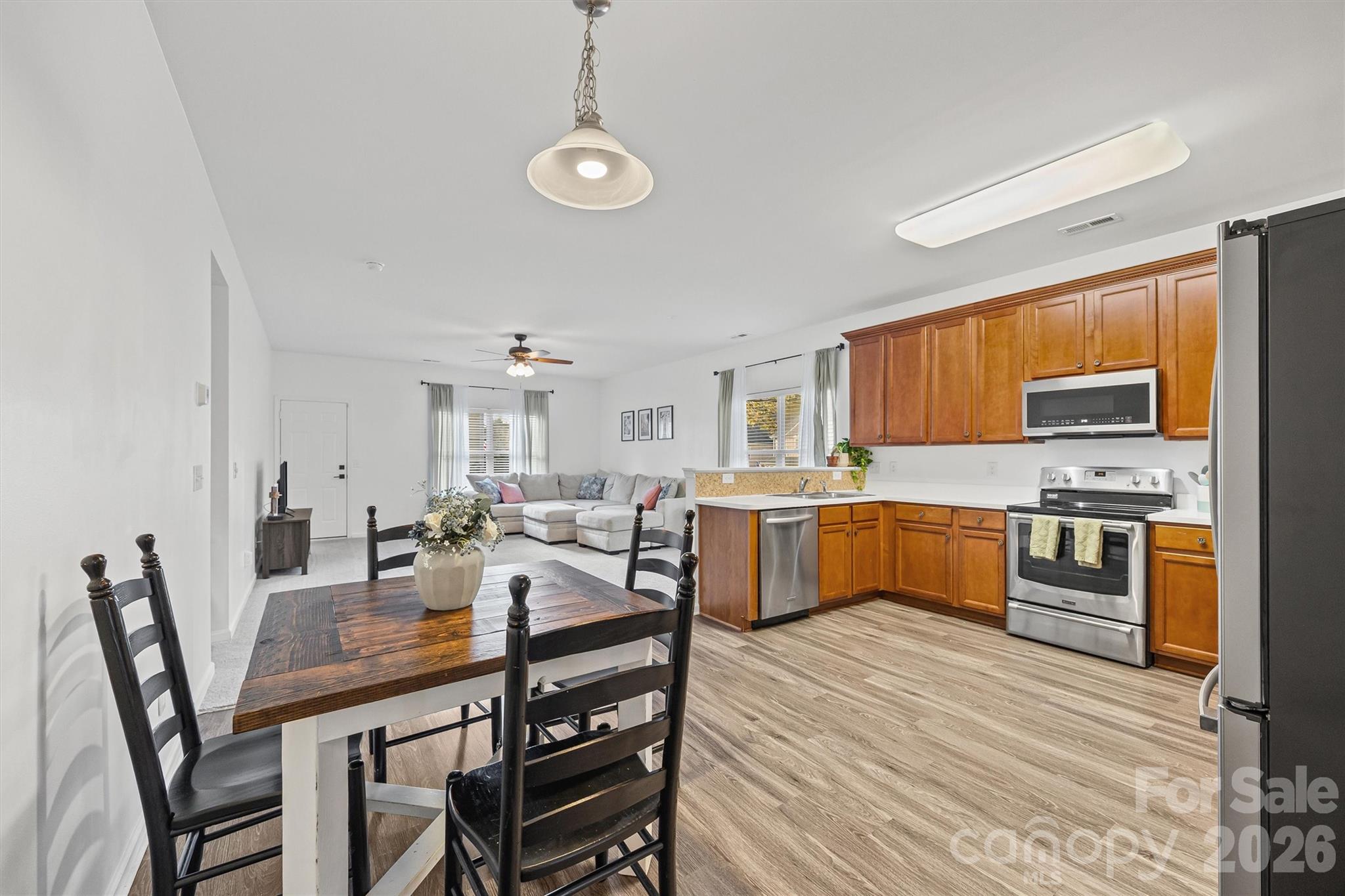2133 Seabrook Lane Fort Mill, SC 29715 - Photo 6 of 28 a open kitchen with stainless steel appliances kitchen island granite countertop a table chairs and a refrigerator