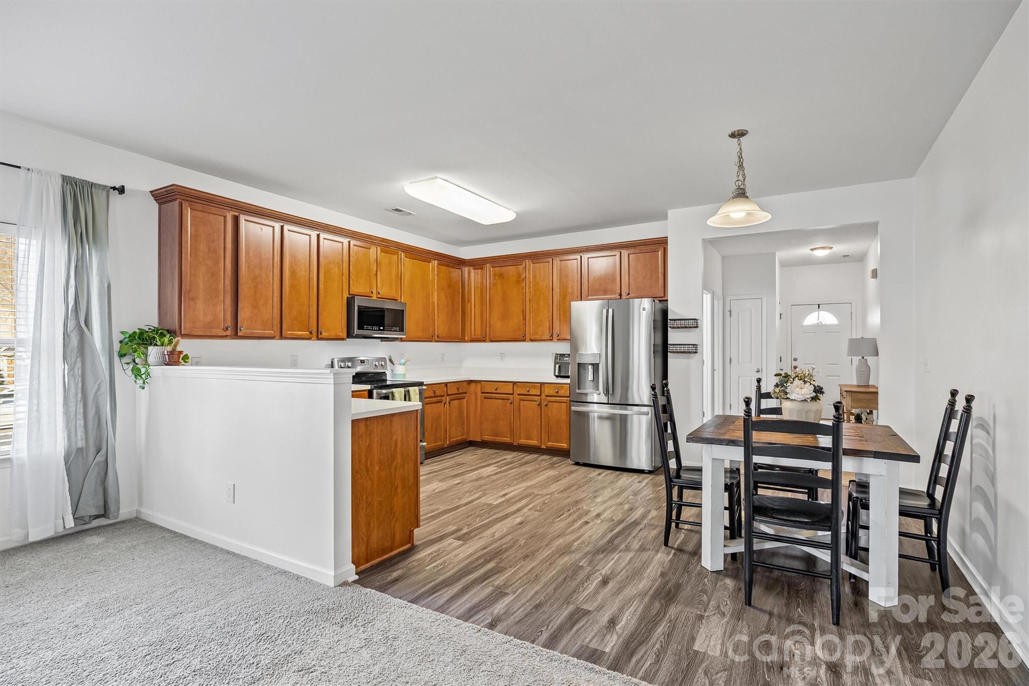 2133 Seabrook Lane Fort Mill, SC 29715 - Photo 10 of 28 a kitchen with stainless steel appliances a stove a sink island and a refrigerator