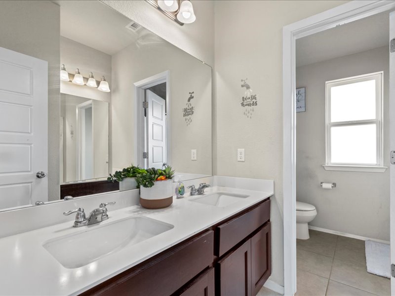 204 Lake Placid Run Elgin, TX 78621 - Photo 11 of 19 a bathroom with a sink double vanity and a mirror