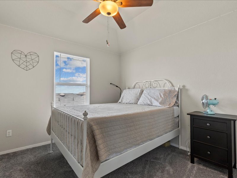 204 Lake Placid Run Elgin, TX 78621 - Photo 12 of 19 a bedroom with a bed and a cabinets