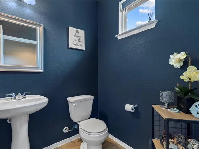 a bathroom with a toilet sink and mirror