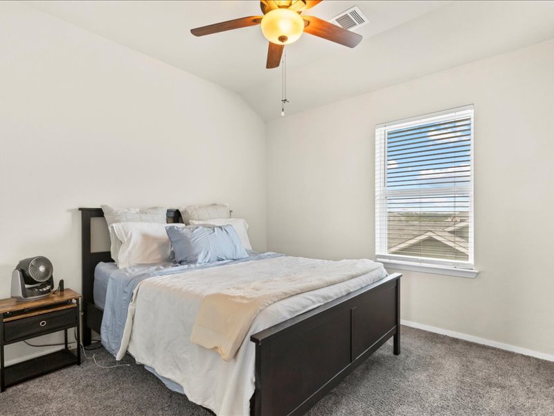 204 Lake Placid Run Elgin, TX 78621 - Photo 14 of 19 a bedroom with bed and window