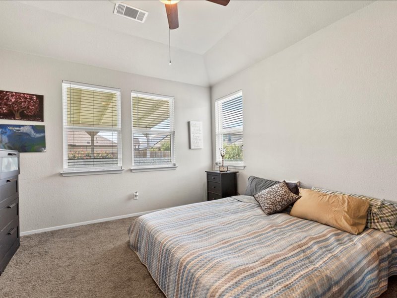 204 Lake Placid Run Elgin, TX 78621 - Photo 15 of 19 a bedroom with a bed and a window