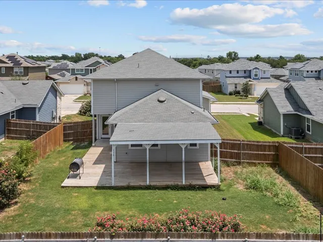an aerial view of a house with a yard