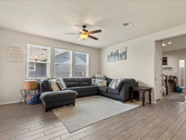 a living room with furniture and a large window