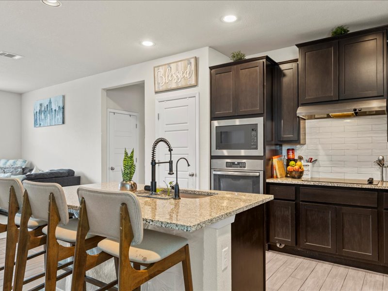 204 Lake Placid Run Elgin, TX 78621 - Photo 7 of 19 a kitchen with stainless steel appliances a sink and a refrigerator