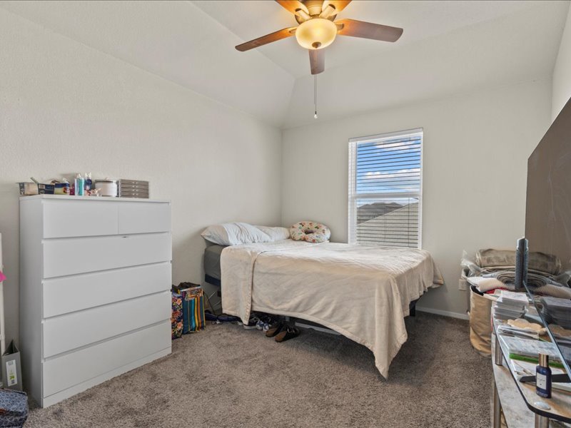 204 Lake Placid Run Elgin, TX 78621 - Photo 10 of 19 a room with a bed and a chandelier