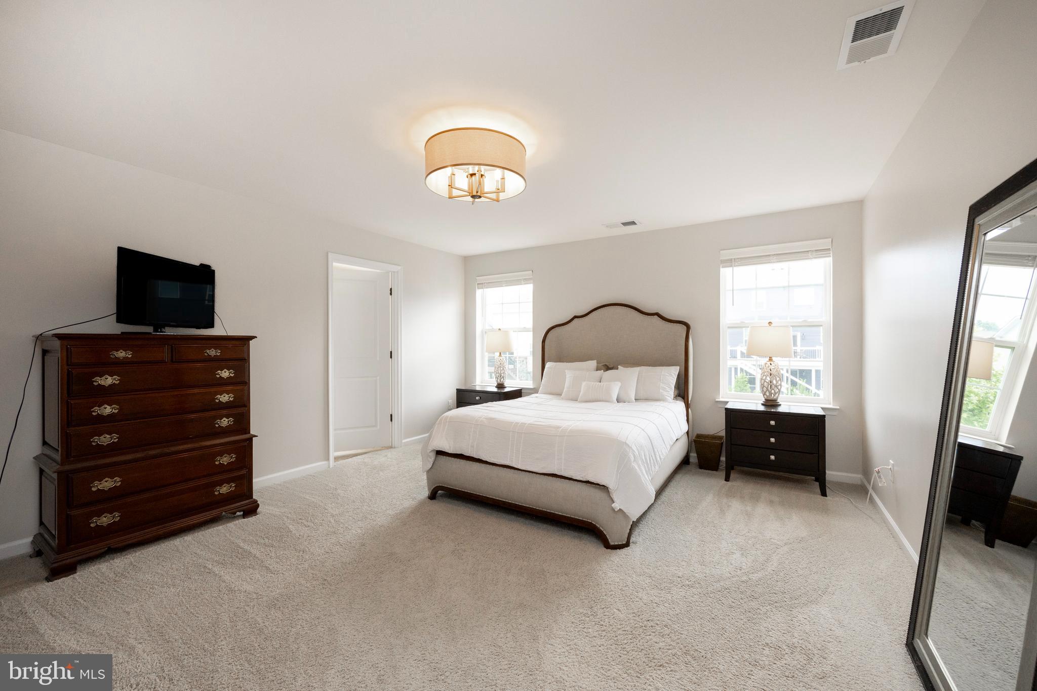 45 Nichols Mill Road Downingtown, PA 19335 - Photo 21 of 47 a bedroom with a bed and a flat tv screen on dresser