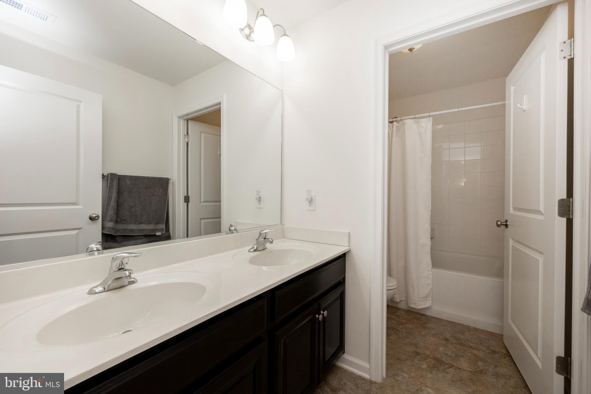 45 Nichols Mill Road Downingtown, PA 19335 - Photo 27 of 47 a bathroom with a double vanity sink a and mirror