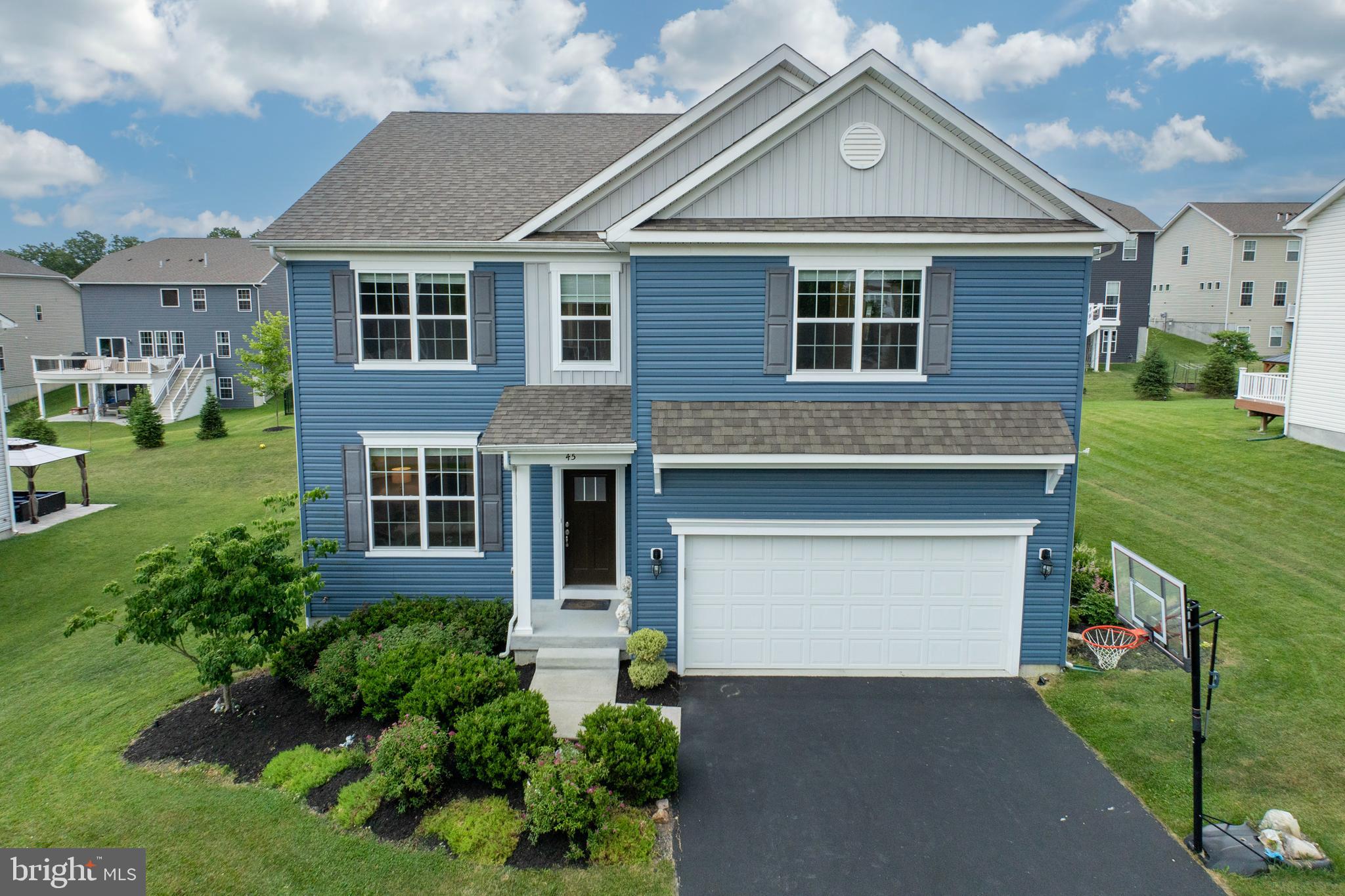 45 Nichols Mill Road Downingtown, PA 19335 - Photo 36 of 47 a front view of a house with a garden and plants