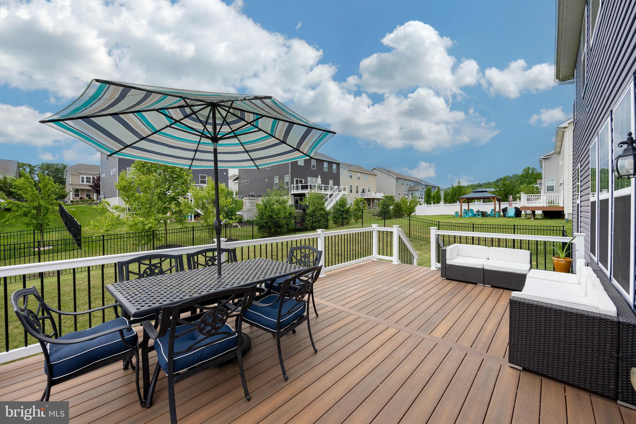 45 Nichols Mill Road Downingtown, PA 19335 - Photo 45 of 47 a view of a chairs and table on the wooden deck