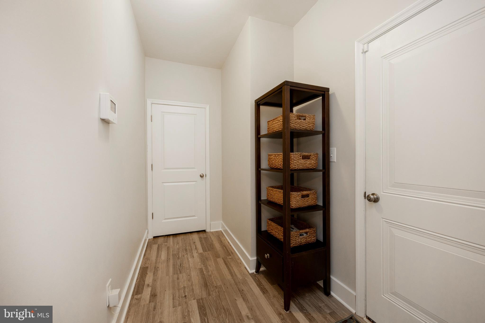 45 Nichols Mill Road Downingtown, PA 19335 - Photo 7 of 47 a view of a hallway with wooden floor and closet