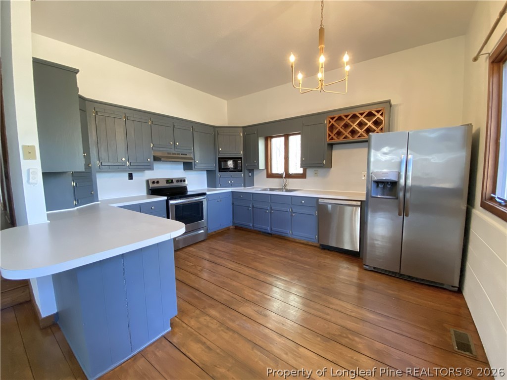 45 Lookout Point Sanford, NC 27332 - Photo 4 of 15 a kitchen with stainless steel appliances kitchen island granite countertop a sink stove and refrigerator
