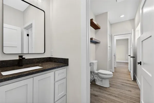a bathroom with a shower a toilet and sink