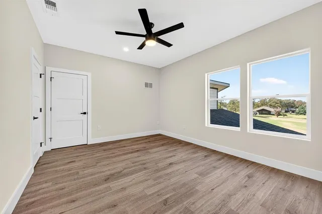 a bathroom with a granite countertop toilet sink and mirror