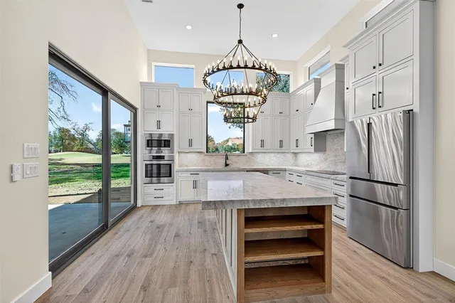 a kitchen with kitchen island granite countertop a stove and refrigerator