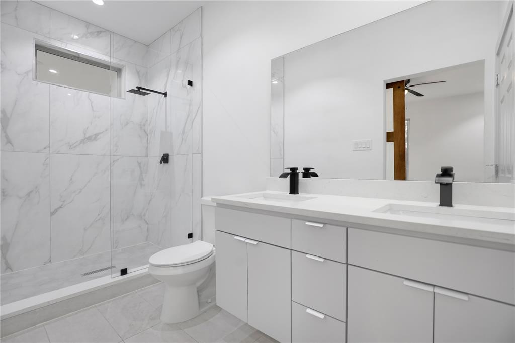 2606 Fordham Road Dallas, TX 75216 - Photo 18 of 19 Bathroom featuring a dual vanity with white cabinetry, integrated sinks, and matte black fixtures