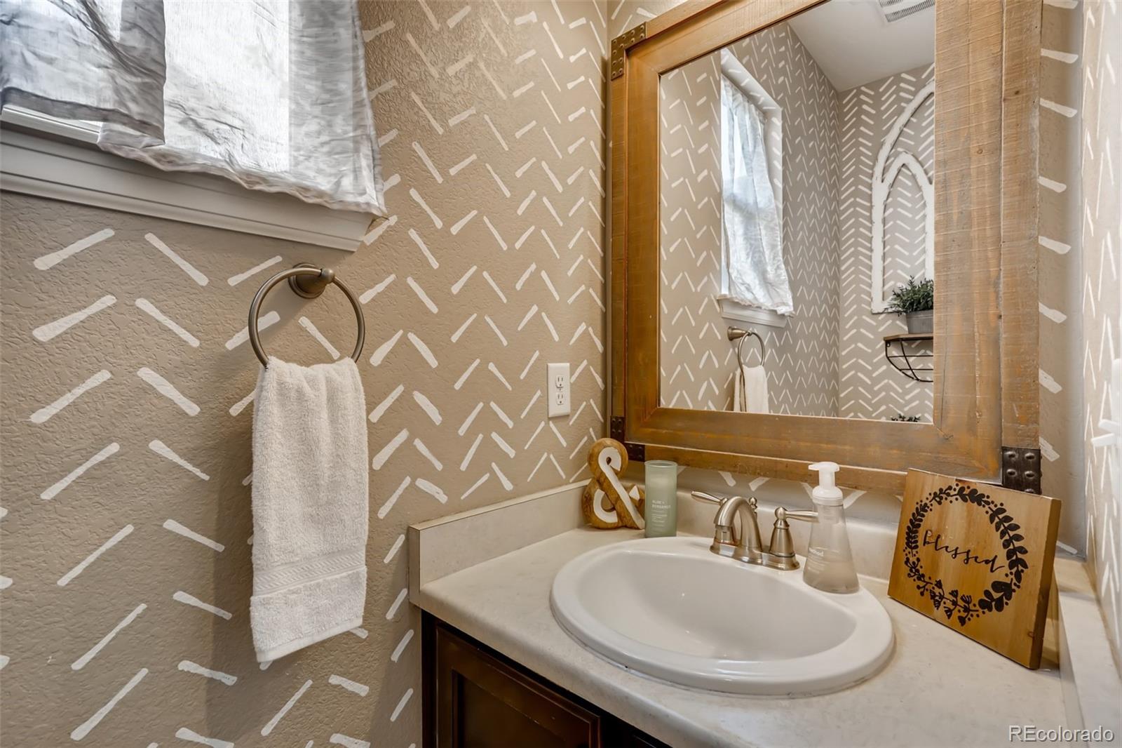 8537 Raspberry Drive Frederick, CO 80504 - Photo 11 of 31 a bathroom with a sink and a mirror