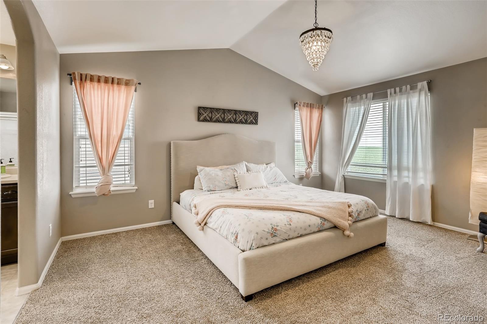 8537 Raspberry Drive Frederick, CO 80504 - Photo 12 of 31 a large bed sitting in a bedroom next to a window
