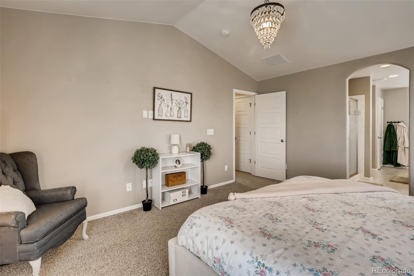 8537 Raspberry Drive Frederick, CO 80504 - Photo 13 of 31 a bedroom with a bed and a chandelier